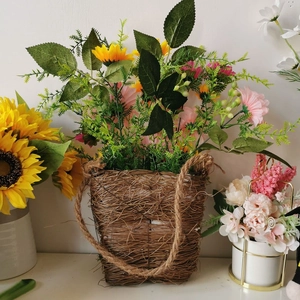 Handwoven straw flower basket with artificial sunflowers and daisies for wall decoration