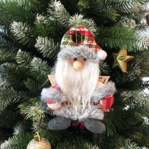 Close-up of Santa Claus ornament with plaid fabric and a star-shaped wooden sign