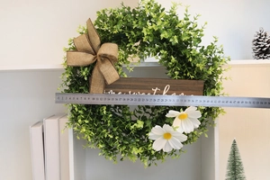 Detail of 40cm eucalyptus wreath with white daisies and Home Sweet Home wooden sign