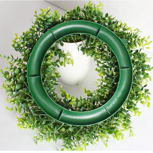 Artificial eucalyptus wreath with green plastic frame support for hanging decoration