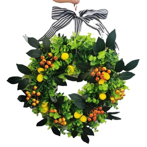 Artificial summer lemon and berry wreath with green leaves and black striped ribbon bow