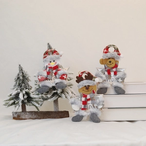 Detail of Christmas plush pendants featuring snowman, elk, and bear with red plaid fabric