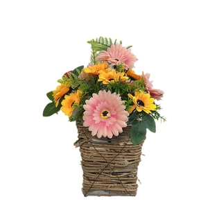 Artificial gerbera daisy floral arrangement in a woven rattan basket for wall decoration
