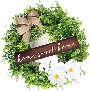 Artificial eucalyptus wreath with white daisies and a wooden Home Sweet Home sign