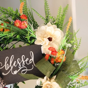 Fall wreath with white flowers, orange blossoms and a wooden blessed sign for home decor