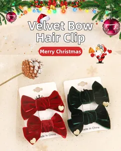 Detail of red and green velvet bow hair clips with heart sequins for Christmas styling