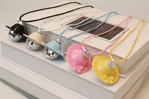 Detailed view of colorful mini disco ball hat charms with reflective mirror surfaces