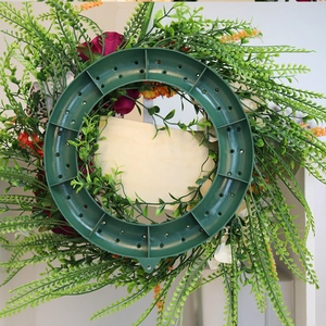 Rear view of the Thanksgiving wreath showing the green plastic frame and artificial foliage