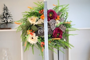 Close-up of Thanksgiving wreath with Blessed wood sign and mixed leaf textures