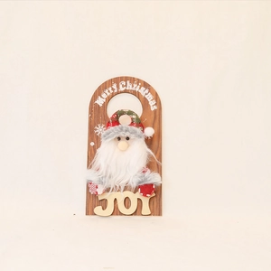 Detail of wooden Merry Christmas door hanger featuring a 3D plush Santa Claus and JOY text
