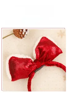 Detail of red velvet Christmas bow with white teddy plush trim and handmade label tag