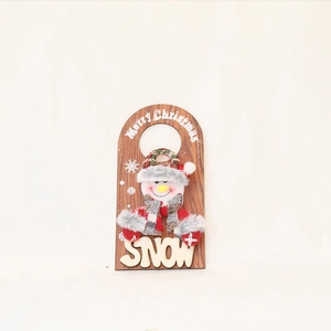 Detail of Christmas wooden door sign with plush snowman and Merry Christmas lettering
