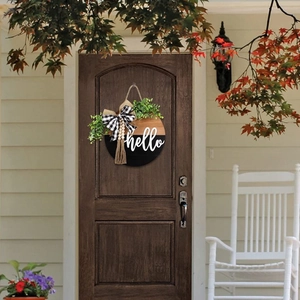 30cm round wooden Hello door sign with black bow and greenery in rustic farmhouse style