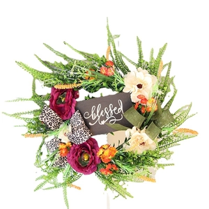 Artificial Thanksgiving wreath with green leaves, flowers, and Blessed wooden sign