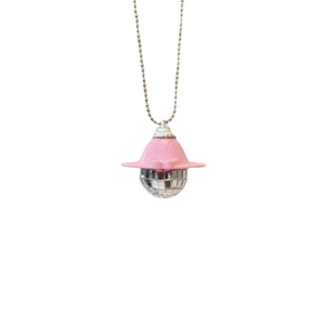 Pink sun hat with a sparkling silver disco ball pendant necklace on a white background