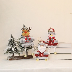 Three Christmas plush ornaments with bells featuring Santa, elk and snowman designs