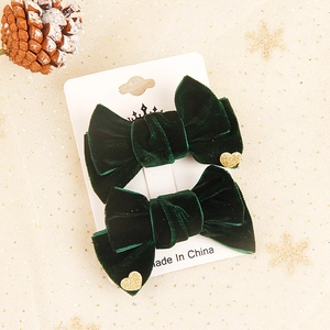 Dark green velvet hair clips with gold glitter hearts for festive Christmas holiday styling