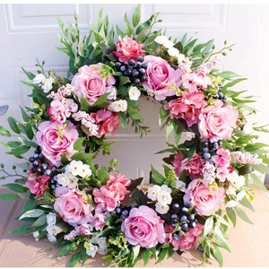 Artificial rose wreath with pink flowers and blue berries for home wall and door decor