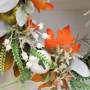Autumn harvest wreath featuring faux pumpkins, maple leaves, and berries for door decor