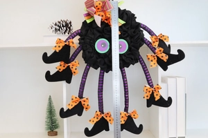 Halloween long-legged spider witch ornament with purple striped legs and size measurement scale