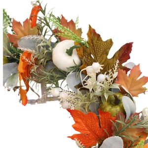 Fall harvest wreath with colorful maple leaves and mini pumpkins on white background