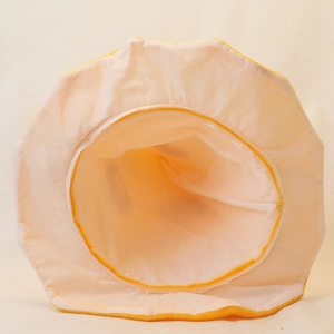 Detail view of the soft plush lining and interior structure of the yellow Halloween pumpkin hat