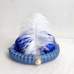 Close-up of blue satin Aladdin hat with sequins, white pearls and an exotic feather