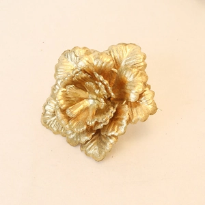Detailed macro view of golden artificial Christmas flower petals with shimmering glitter finish