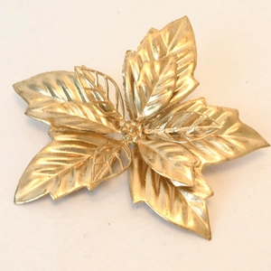 Detailed top view of gold artificial Christmas flower clips with intricate hollow leaves