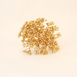 Detailed view of artificial gold Christmas flower accessories with metallic floral texture