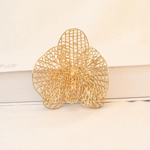 Detailed macro view of golden hollowed orchid flower ornament with mesh texture for decor