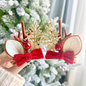 Christmas reindeer antler hair clips set with red velvet bows and golden pine tree decor