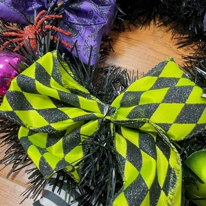 Halloween wreath with neon yellow plaid bow and red glitter spiders for door decor