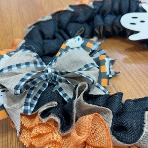 Detail of mesh fabric textures and Halloween BOO ribbon on a ghost wreath decoration