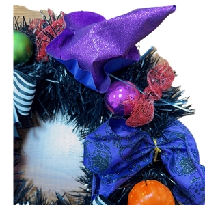 Halloween wreath with purple wizard hat, orange pumpkin, and colorful festive decorations