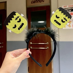 Halloween headband with green Frankenstein heads featuring glitter finish and spring detail