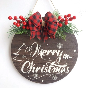 Round wooden Merry Christmas door hanger with red buffalo plaid bow and pine cones