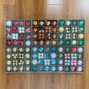 Detail of assorted Christmas tree ball sets with matte and glitter finishes on wood floor