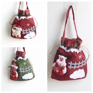 Detailed view of handmade Christmas burlap gift bags with 3D Santa and reindeer embroidery