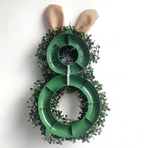 Easter rabbit door wreath with green foliage and burlap ears, back view of plastic frame