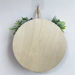 Round wooden Fourth of July welcome door sign with artificial greenery and jute rope