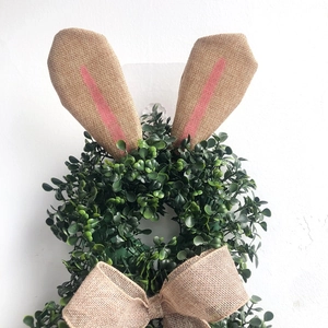 Easter bunny shaped green plant wreath with burlap rabbit ears and bow for home decor