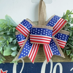 Patriotic wooden Independence Day welcome door sign with American flag burlap bow and greenery
