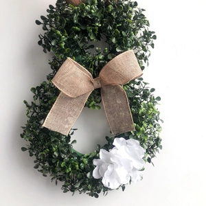 Easter figure 8 wreath with green foliage, burlap bow and white flowers for home decor