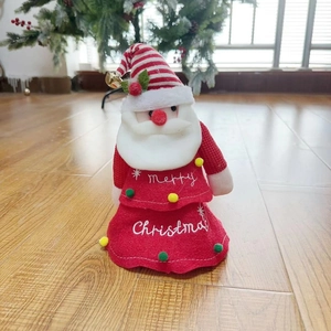 Detail of Santa plush toy with Merry Christmas embroidery and festive golden bell