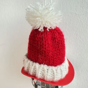Handmade red and white knitted Christmas hat keychain ornament for festive bag decoration