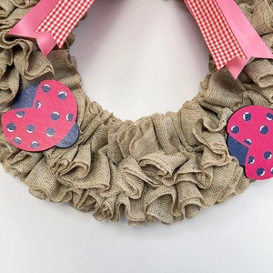 Handmade burlap wreath with pink plaid bow and ladybug accents for home wall decor