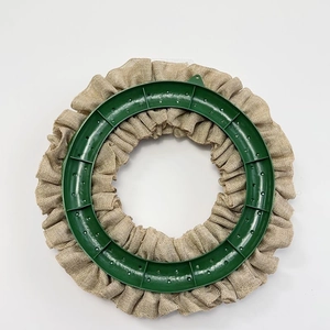 Detail of DIY burlap wreath base with brown natural fibers on a green plastic frame