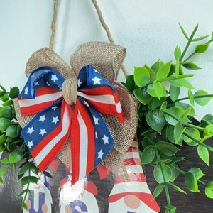Patriotic USA Independence Day door hanger with burlap bow and artificial greenery