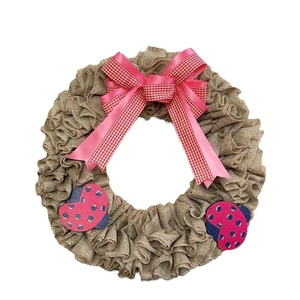 Handmade burlap wreath with pink ribbon bow and cute ladybugs for home wall door decoration